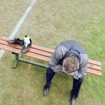 Man on bench with head in hands